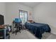 Bedroom featuring a dark blue bed, desk, and a gaming setup near the window at 1442 Morningside Dr, Burlington, NC 27217