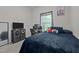 Bedroom with a dark blue bed, desk, gaming setup and entertainment center at 1442 Morningside Dr, Burlington, NC 27217