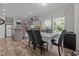 The dining area features gray trim, modern chairs and a view of the lawn through a window at 1442 Morningside Dr, Burlington, NC 27217