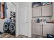 The laundry room features extra storage and a modern washer and dryer at 1442 Morningside Dr, Burlington, NC 27217