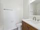 Modern bathroom with wood vanity, white countertop, and tile flooring at 15 Canary Ct, Durham, NC 27713