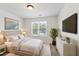 Bright bedroom featuring a large window, stylish furniture, and modern decor at 15 Canary Ct, Durham, NC 27713