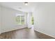 Empty bedroom with hardwood floors and window bringing in natural light at 15 Canary Ct, Durham, NC 27713