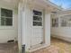 Exterior door to the home with a window, brick foundation and gutter at 1521 N Duke St, Durham, NC 27701