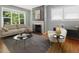 Inviting living room with fireplace, large window, neutral color palette and hardwood floors at 1521 N Duke St, Durham, NC 27701