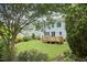 Backyard view featuring a well-manicured lawn and a charming deck at 1601 Bellenden Dr, Durham, NC 27713