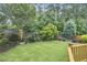 A well-maintained lawn and landscaping with privacy fence is featured in this spacious backyard at 1601 Bellenden Dr, Durham, NC 27713