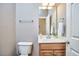 Half bathroom features a pedestal sink with wooden cabinet and modern fixtures at 1601 Bellenden Dr, Durham, NC 27713