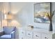 Cozy bedroom corner featuring dresser, lamp, chair, and artwork at 1601 Bellenden Dr, Durham, NC 27713