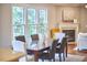 Elegant dining area with fireplace, ample natural light, and stylish furnishings for comfortable gatherings at 1601 Bellenden Dr, Durham, NC 27713
