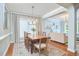 Formal dining room with wood floors, a modern chandelier, and an open view to the living area at 1601 Bellenden Dr, Durham, NC 27713