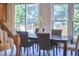 Bright dining room features a dark wood table, six chairs and sliding glass doors to the outdoor deck at 1601 Bellenden Dr, Durham, NC 27713