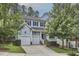 Charming two-story home with a two-car garage, black shutters, and a well-manicured front yard at 1601 Bellenden Dr, Durham, NC 27713