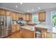 Bright kitchen featuring stainless steel appliances, wood cabinets, granite countertops, and a connected deck at 1601 Bellenden Dr, Durham, NC 27713