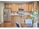 Spacious kitchen featuring stainless steel appliances, an island, and classic wood cabinets at 1601 Bellenden Dr, Durham, NC 27713