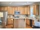 Bright kitchen with stainless steel appliances, wood cabinets, granite countertops, and hardwood floors at 1601 Bellenden Dr, Durham, NC 27713