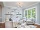 Cozy living room featuring a modern chandelier, floating shelves, and large window at 1601 Bellenden Dr, Durham, NC 27713