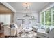Inviting living room with modern furniture, decor, and a large window overlooking trees at 1601 Bellenden Dr, Durham, NC 27713
