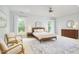 Bright main bedroom with natural light, ceiling fan, comfortable seating, and a dresser at 1601 Bellenden Dr, Durham, NC 27713
