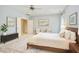 Spacious main bedroom with neutral colors, ceiling fan, and a comfortable bed at 1601 Bellenden Dr, Durham, NC 27713