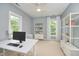 Modern office space with a computer, shelving, and natural light at 1601 Bellenden Dr, Durham, NC 27713