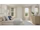 Sunlit bedroom featuring a large window, stylish lamps, neutral bedding, and soft, elegant curtains at 164 Paramount Dr, Smithfield, NC 27577