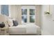 Inviting bedroom features a bright window, lamps, neutral bedding, and tasteful decor at 164 Paramount Dr, Smithfield, NC 27577