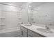 Bathroom with double sinks, bathtub-shower combo, and quartz countertops at 167 Young Farm Dr, Lillington, NC 27546