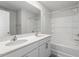 Bathroom has double sinks with quartz countertops and a bathtub-shower combo at 167 Young Farm Dr, Lillington, NC 27546