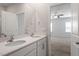 Bathroom has double sinks with quartz countertops and a large mirror at 167 Young Farm Dr, Lillington, NC 27546