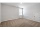 Neutral bedroom featuring carpet, white walls, a window, and a door to a closet at 167 Young Farm Dr, Lillington, NC 27546