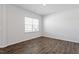 Light-filled bedroom featuring modern flooring, neutral paint, and a large window at 167 Young Farm Dr, Lillington, NC 27546