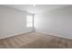 Neutral bedroom featuring carpet, white walls, a window, and overhead lighting at 167 Young Farm Dr, Lillington, NC 27546