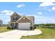 Charming two-story home with a welcoming porch and attached garage, surrounded by greenery at 167 Young Farm Dr, Lillington, NC 27546
