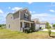 Two-story home showcasing a charming front porch, attached garage, and manicured lawn at 167 Young Farm Dr, Lillington, NC 27546