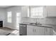Kitchen view with stainless steel appliances, white cabinets, a double sink, and natural light from the windows at 167 Young Farm Dr, Lillington, NC 27546