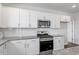 Close up on a kitchen with stainless appliances, subway tile backsplash, and granite countertops at 167 Young Farm Dr, Lillington, NC 27546