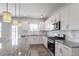 Well-lit kitchen with stainless steel appliances, granite countertops, and white cabinetry at 167 Young Farm Dr, Lillington, NC 27546