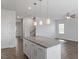 Bright kitchen with a granite island, white cabinets, and views of the living room and staircase at 167 Young Farm Dr, Lillington, NC 27546