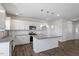 Spacious kitchen featuring stainless appliances, granite countertops, white cabinets, and central island at 167 Young Farm Dr, Lillington, NC 27546