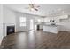 Open-concept living area showcasing modern flooring, a fireplace, a kitchen island, and stainless steel appliances at 167 Young Farm Dr, Lillington, NC 27546
