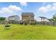 Large backyard with lush lawn, swing set, and patio with grill at 19 Kimberly Ct, Lillington, NC 27546