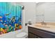 Bathroom featuring a tub with a colorful ocean-themed shower curtain, and a vanity at 19 Kimberly Ct, Lillington, NC 27546