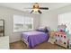 Bright bedroom featuring a ceiling fan, window, and cute castle playhouse at 19 Kimberly Ct, Lillington, NC 27546