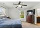Cozy bedroom features a ceiling fan, window with view, and adjacent bathroom at 19 Kimberly Ct, Lillington, NC 27546