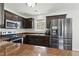 Modern kitchen featuring stainless steel appliances, brown countertops, and dark wood cabinets at 19 Kimberly Ct, Lillington, NC 27546