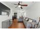 Inviting living room with hardwood floors, ceiling fan, and modern gray sofa at 19 Kimberly Ct, Lillington, NC 27546