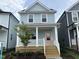 Charming two-story home with a welcoming porch and a pink front door at 1915 Plott Balsam Dr, Wendell, NC 27591