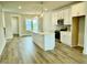 Kitchen with a central island, wood floors, and white cabinets at 1915 Plott Balsam Dr, Wendell, NC 27591
