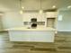 Modern kitchen with a large island, pendant lighting, and stainless steel appliances at 1915 Plott Balsam Dr, Wendell, NC 27591